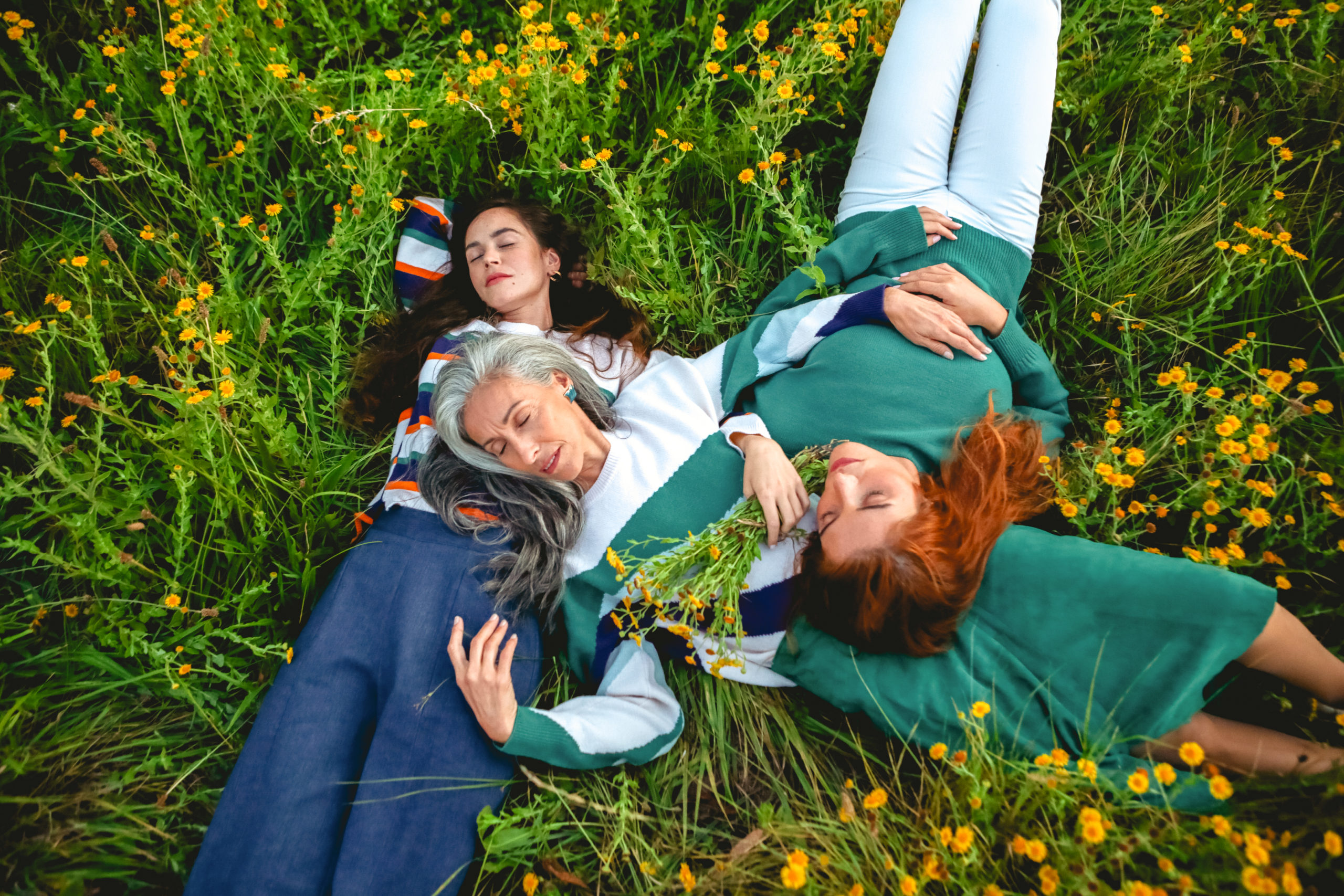 Image représentant trois femmes allongées dans l’herbe et posant pour la jeune marque Chandam